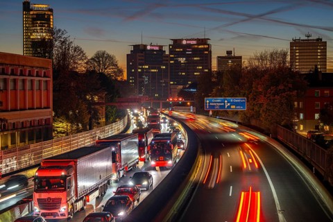 Evening traffic, partly with traffic jams, slow-moving traffic on the A40 motorway, skyline of