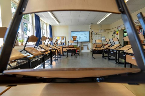 Classroom of a fourth grade, after school, the building is older but in good condition, modern