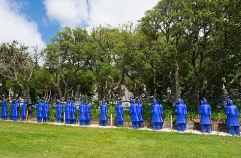 A row of blue terracotta soldier statues stands in a park-like setting, Bacalhôa, Bacalhoa Buddha