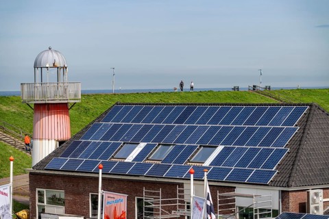 Solar modules on roofs, on the roof of a building on the dyke, North Sea coast, in Zeeland,