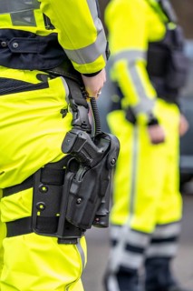 Police, policeman, weapon in thigh holster, uniform of the motorway police North Rhine-Westphalia