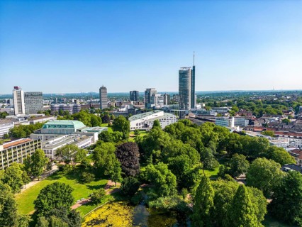 The skyline of Essen city centre, with the RWE Tower on the right and Stadtgarten Park in front,
