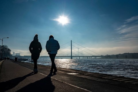 Dense fog is slowly lifting, riverside promenade on the Rhine near Düsseldorf, in front the