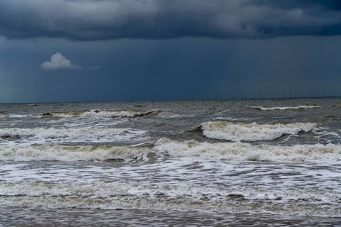Beach, dark storm clouds, choppy sea, autumn on the North Sea in North Holland, between the towns