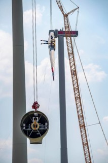 Erection of an Enercon E-160 wind turbine, rear, assembly of the first blade, 4 turbines with a