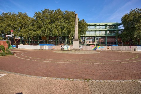Roundabout with memorial to the fall of the Berlin Wall and the renovation of the town hall in