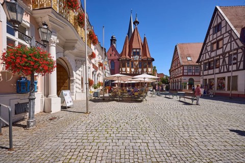 Market square with lantern, outdoor area of a café and historic town hall in Michelstadt, Odenwald,