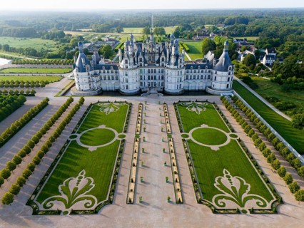 Impressive castle with magnificent symmetrical gardens and Renaissance architecture, seen from the