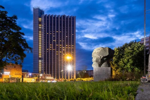 Karl Marx Monument at night. A 40-tonne sculpture, the city's most famous landmark. Congress Hotel.