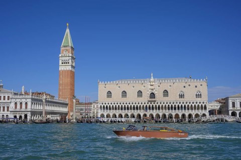 Taxi boat behind St Mark's Square tower and Palazzo Ducale, Venice, Metropolitan City of Venice,