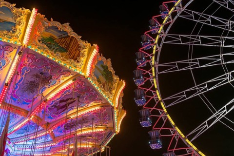 A funfair at night with illuminated chain carousel and Ferris wheel, Europa Rad, rides, wave