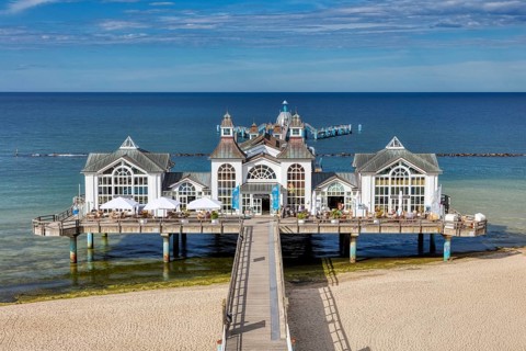 Impressive pier with white pavilions and a relaxed beach atmosphere, Rügen
