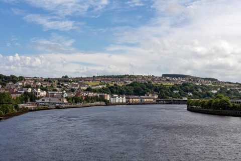 River with neighbouring city under blue sky and clouds, Londonderry