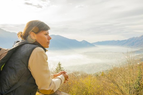 Woman Enjoy Panoramic View over Mountain Scape with a Foggy Valley in Locarno, Ticino, Switzerland,