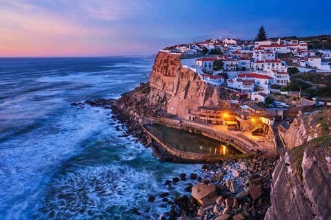 Scenic view of the seaside Azenhas do Mar fishing village on cliff on Atlantic ocean coast,