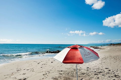Lonely beach and parasol, Spiaggia di Biderosa, Riserva Biderosa nature reserve, Orosei, Nuoro