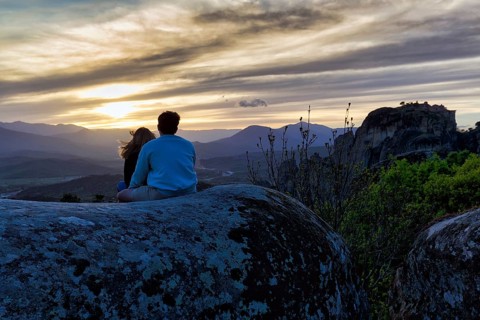Couple enjoying the view of Meteora, sunset, Thessaly, Greece, Europe