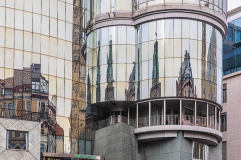 Reflections on the glass façade of the Haas Haus on Stephans-Platz, Vienna, Austria, Europe