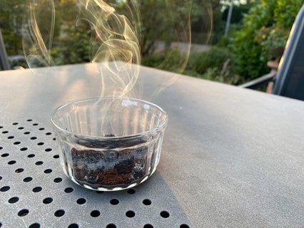 Coffee in a glass jar, on a table, lit, burning, smoking, to repel wasps, Stuttgart,