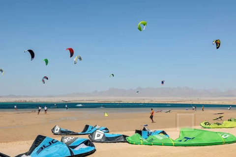 Sailing kitesurfers kite surfers kite surfers on the sea, many kite sails in the blue sky without