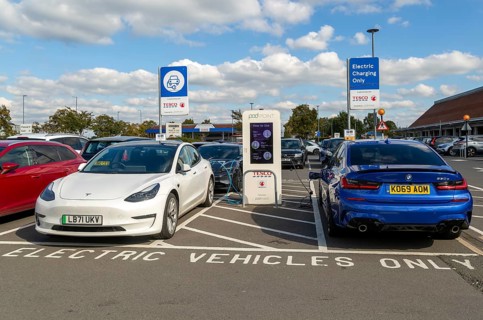 Electric vehicles charging Pod Point, Tesco Extra supermarket carpark, Swindon, Wiltshire, England,
