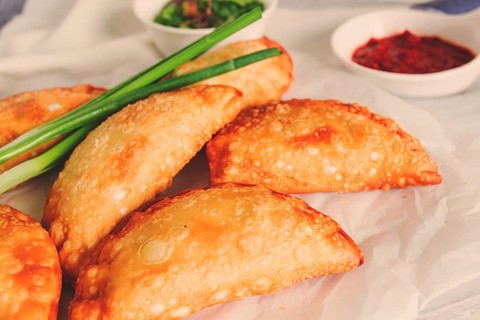 Fried chebureks, close-up, on a light background, no people