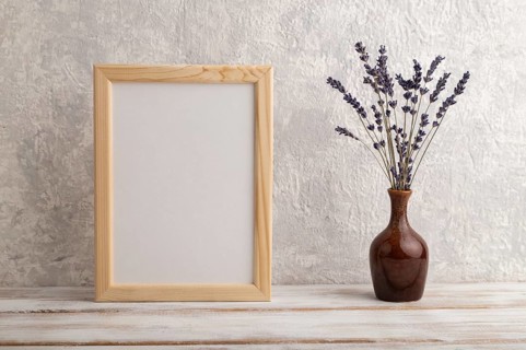 White wooden frame mockup with lavender in ceramic vase on gray concrete background. Blank,