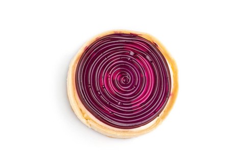 Single sweet tartlet with jelly and milk cream isolated on white background. Top view, close up