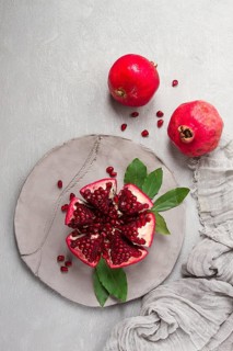 Fresh, cut pomegranate fruit, on a gray background, food concept, top view, no people