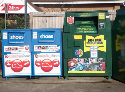 Shoe and Book Bank recycling collection containers at a Tesco store, UK