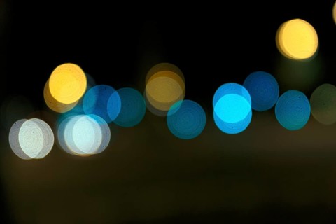 Bokeh balls, abstract dark background with blue and yellow lights, night shot, Barcelona, Spain,