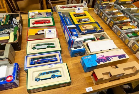 Boxes of Corgi model buses, coaches and other vehicles on display at auction, UK