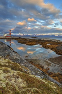 Lighthouse reflected in water, cloudy mood, mountains, coast, Tranoy, Ofoten, Norway, Europe
