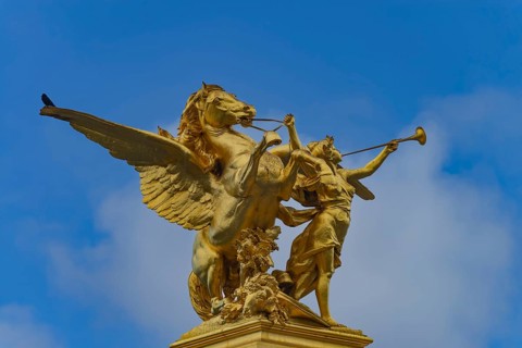 Column with the group of figures Fama of War on the Pont Alexandre III bridge over the Seine,