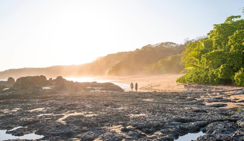 Two people on a sandy beach at sunset, Playa Cocalito, coastal landscape, Pacific coast, Nicoya