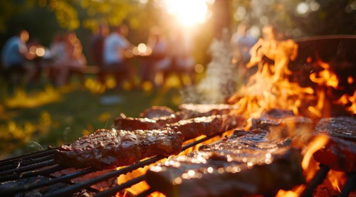 Barbecue BBQ family picnic party on the beach with skewers of meat and meat steaks over charcoal,