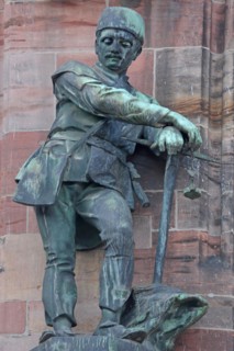 Sculpture Miner with pickaxe as a symbol of industry and mining, statue, figure, bronze, worker,