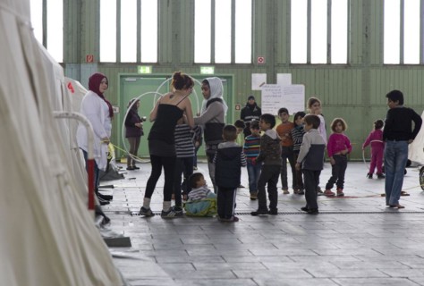 Children of refugees playing between tents in an emergency shelter for refugees on 9 December 2015