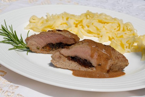 Swabian cuisine, lamb stuffed with prunes, rosemary, herbs, fillets arranged on plates,
