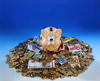 A piggy bank with banknotes and coins, savings, old-age provision, nest egg Studio photo, Lower