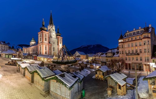 Christmas market in front of the basilica on the main square, blue hour in the early morning,
