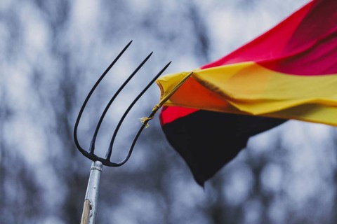 A pitchfork pierces the German flag, taken during the farmers' protests in Berlin, 15 January 2024.