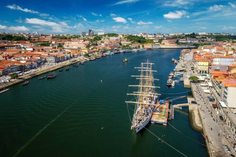 Aerial view of Porto city and Vila Nova de Gaia and Douro river with moored sailling ship from Dom