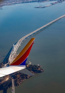San Francisco, California, A Southwest Airlines plane flies over Yerba Buena Island and the San