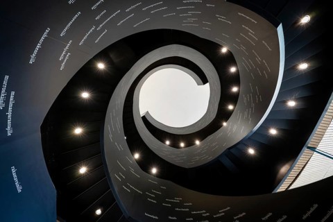 Spiral staircase printed with Finnish words, Oodi Central Library and Cultural Centre, designed by