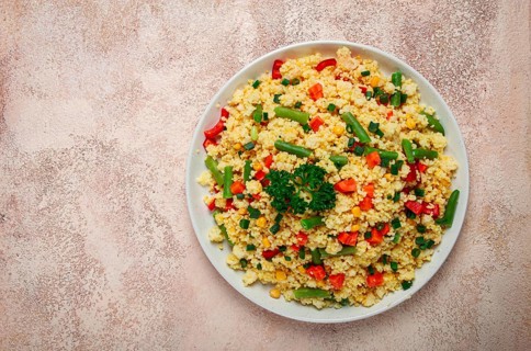 Couscous with vegetables, paprika, carrots, string beans, corn, homemade, top view, no people