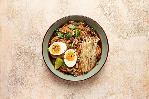 Soba, buckwheat noodles, with enoki mushrooms, shimeji and boiled egg, top view, homemade, no