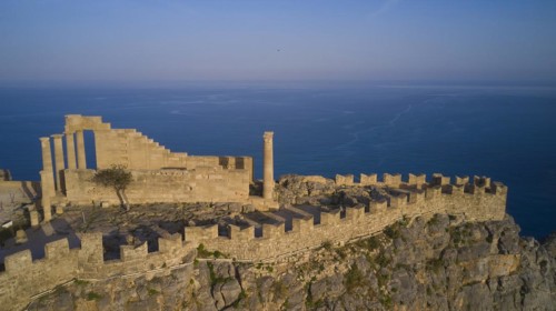 Drone shot, Acropolis of Lindos, late afternoon light, Temple of Athena Lindia, ruins on a rocky