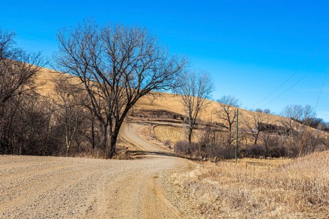 Winding gravel road through the rolling hills of rural western Iowa is part of the Loess Hills