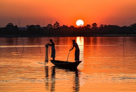 Fishermen fishing in Beki river during sunset, in Barpeta district of Assam, India on 01 Nov. 2019